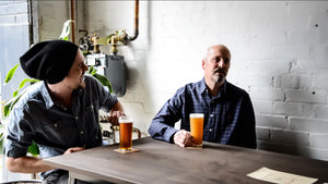 Brewer Mike and his dad sitting at a table drinking beer